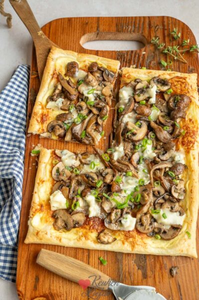 Verdeel de champignonmix en gorgonzola over de plaattaart